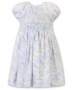 Sarah Louise Girls White Dress With Blue, Pink And Yellow Floral All Over Print With Smocked Detail